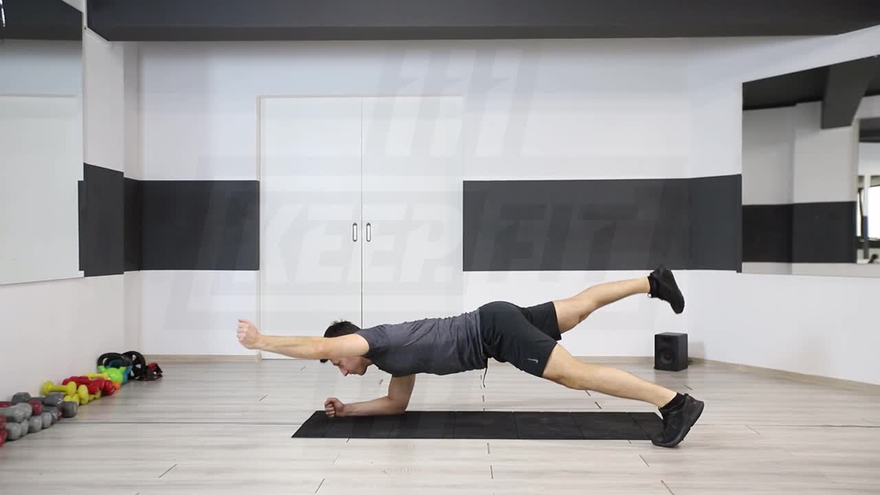 Wide-Stance Plank With Opposite Arm And Leg Lift